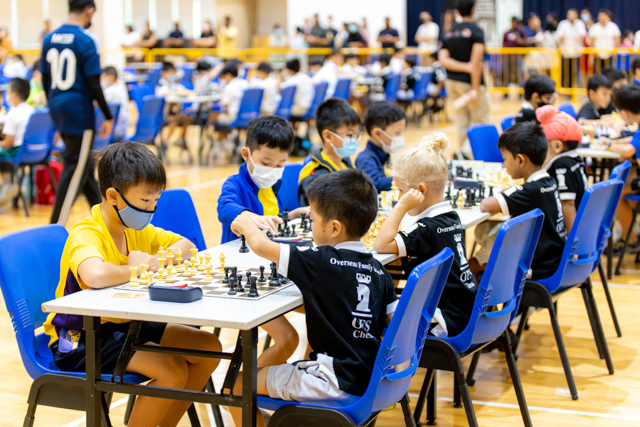 International school children playing chess during a competition