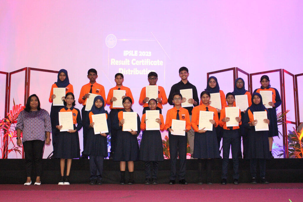 A class of students holding certificates after graduation