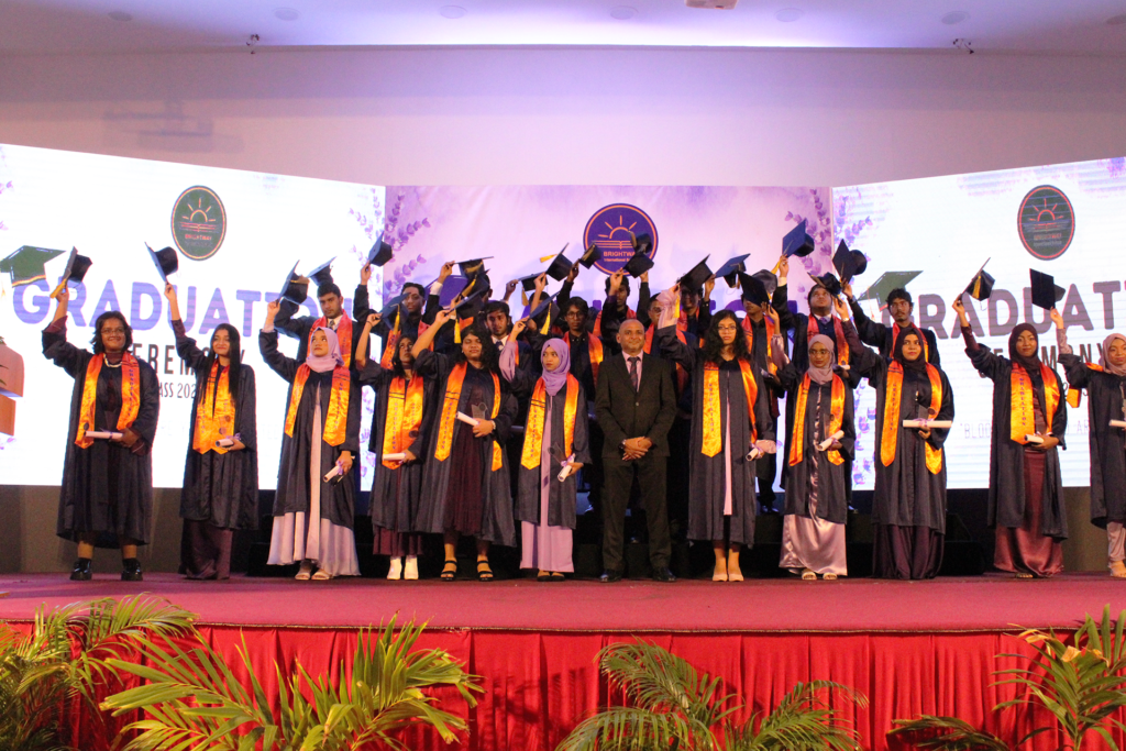 students posing on the stage after receiving awards during an awarding event